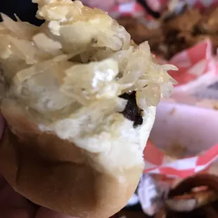 a hand holding a half eaten doughnut