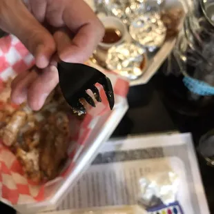 a person holding a fork over a plate of food