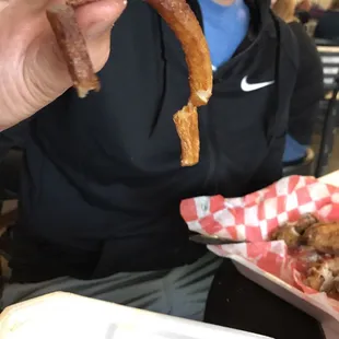 a man holding up a pretzel
