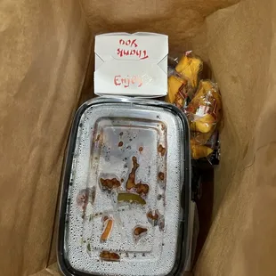 a brown paper bag with food in it