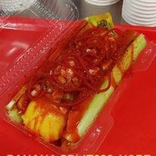 a hot dog in a plastic container