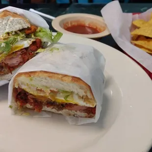 Torta Cubana, featuring grilled meats, hot dog, fried egg, and avocado