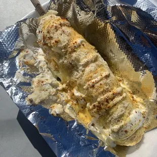 Elote with your choice of Cheetos or Takis...