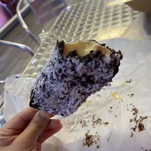 Paleta mango flavored dipped in chocolate and sprinkles with coconut