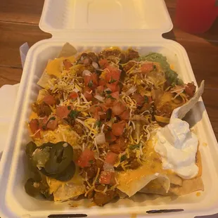 $15 Nachos with Al Pastor and bits of pineapple. Just needed a little more cheese. Otherwise, I really enjoyed it and would order again!