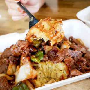 Mofongo topped with pepper steak.