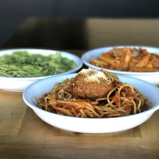 three bowls of spaghetti and meat