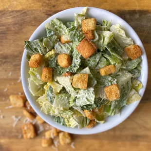 a bowl of salad with croutons