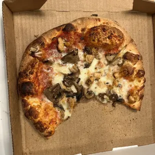 a half eaten pizza in a box