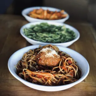 three bowls of spaghetti and meatballs