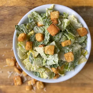 a bowl of caesar salad