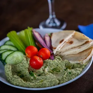 a plate of hummus and vegetables