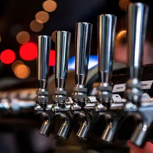 a row of beer taps