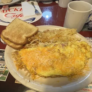 Ham and cheese omelet, with hash browns and white toast.
