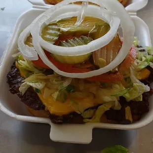 a cheeseburger with onions and lettuce