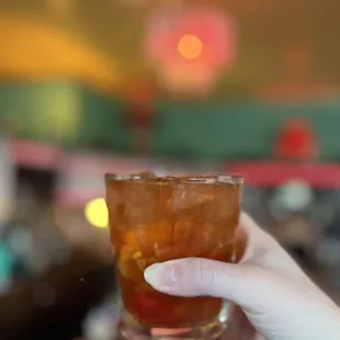 a hand holding a drink