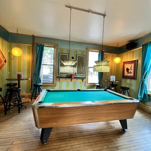 a pool table in the middle of the room