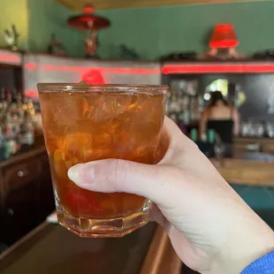 a hand holding a drink