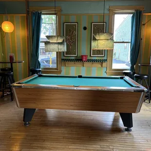 a pool table in the middle of the room