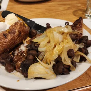 12oz Rib eye with a loaded baked potato and onions, mushrooms and garlic butter sauce