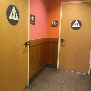 a bathroom with a toilet and a toilet paper dispenser
