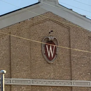 a brick building with a w on it