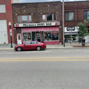 a red car parked on the side of the road