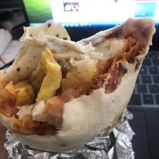 Breakfast bacon burrito with red chile