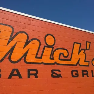a brick wall with the name of a bar and grill