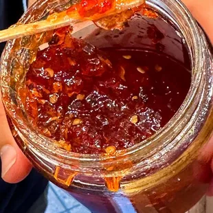 a person holding a jar of jam