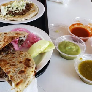 Small beef caramelo, my favorite, salsas, pickled onions and cucumbers from bar.