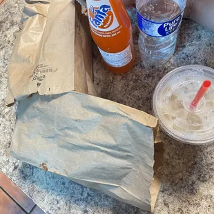 a bag of hot dogs and a drink