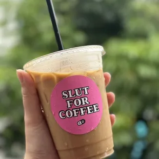 a hand holding a cup of coffee