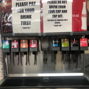 a soda dispenser with drinks