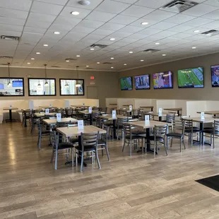 tables and televisions in a restaurant