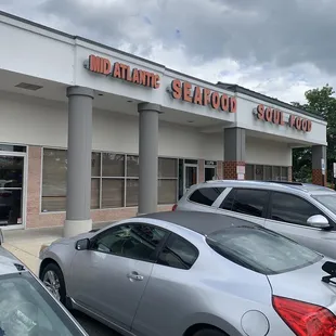 cars parked in front of a restaurant
