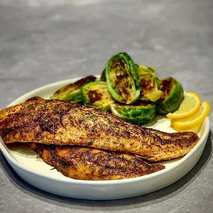 a plate of fish and vegetables