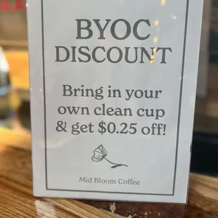 a sign that reads byoc discount bring in your own clean cup and get $ 20 off