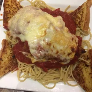 a plate of spaghetti with meat and cheese