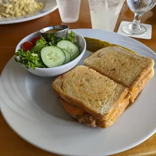 Tuna melt with pickle and a side of greens