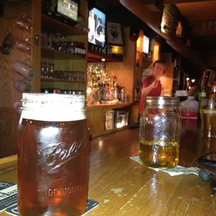 mason jars of beer on a bar