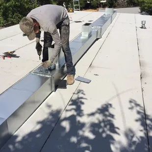 No attic in this apartment. Custom sheet metal to get the job done !