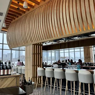 a view of a bar with white chairs