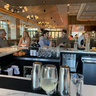 a group of people sitting at a bar