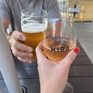 a man and a woman holding glasses of beer