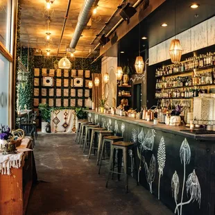 a bar with stools and tables