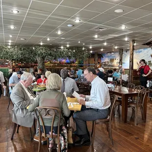 people sitting at tables in a restaurant