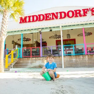 Dine outside on The Porch, and let the kids have fun playing in the sand.