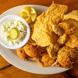 Seafood Platter -- Thin Fried Catfish, Shrimp, Oysters, Stuffed Crab, Cole Slaw, French Fries and Hush Puppies.