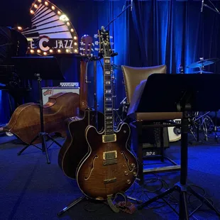 stage with guitar, piano, and other instruments